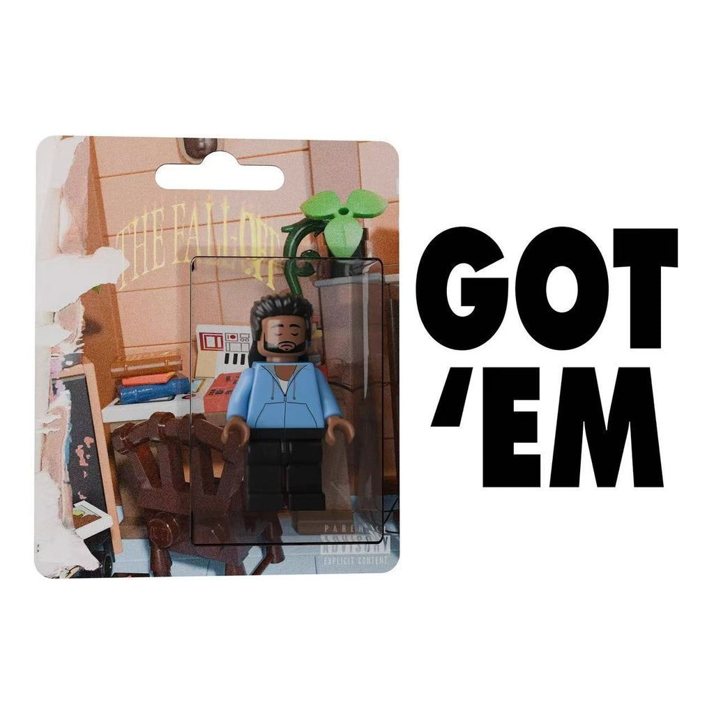 J. Cole "The Fall Off" custom minifigure in blue hoodie, sealed in display packaging with album art background.