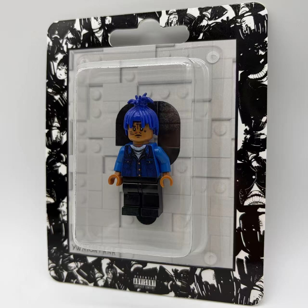 XXXTentacion custom minifigure with blue hair, facial tattoos, sealed in artistic black-and-white blister pack.