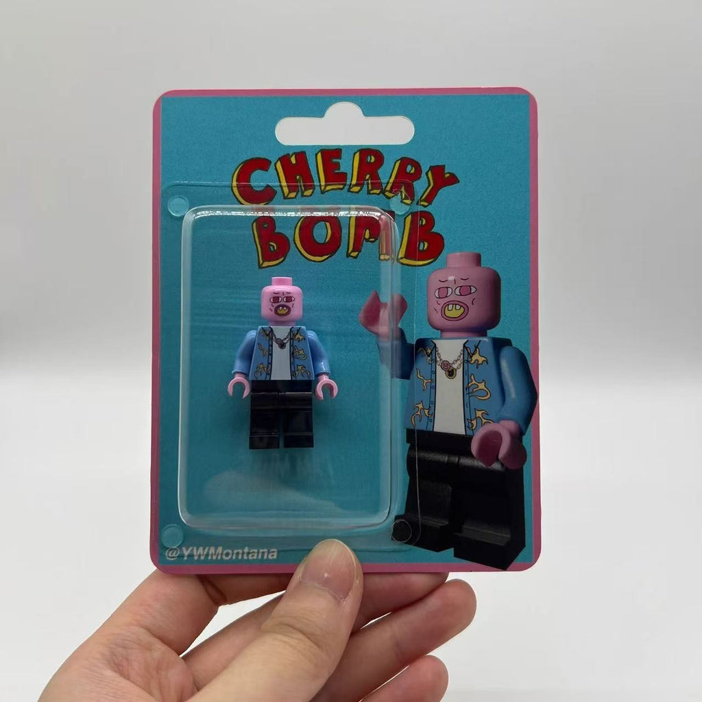 Tyler, The Creator Cherry Bomb custom minifigure in blue shirt, pink mask, sealed in themed packaging.