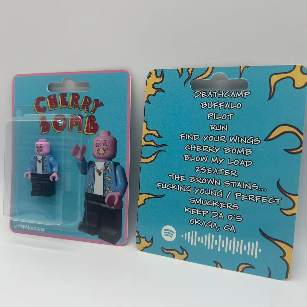 Custom minifigure of Tyler, The Creator with pink mask, blue patterned shirt, and Cherry Bomb art packaging.