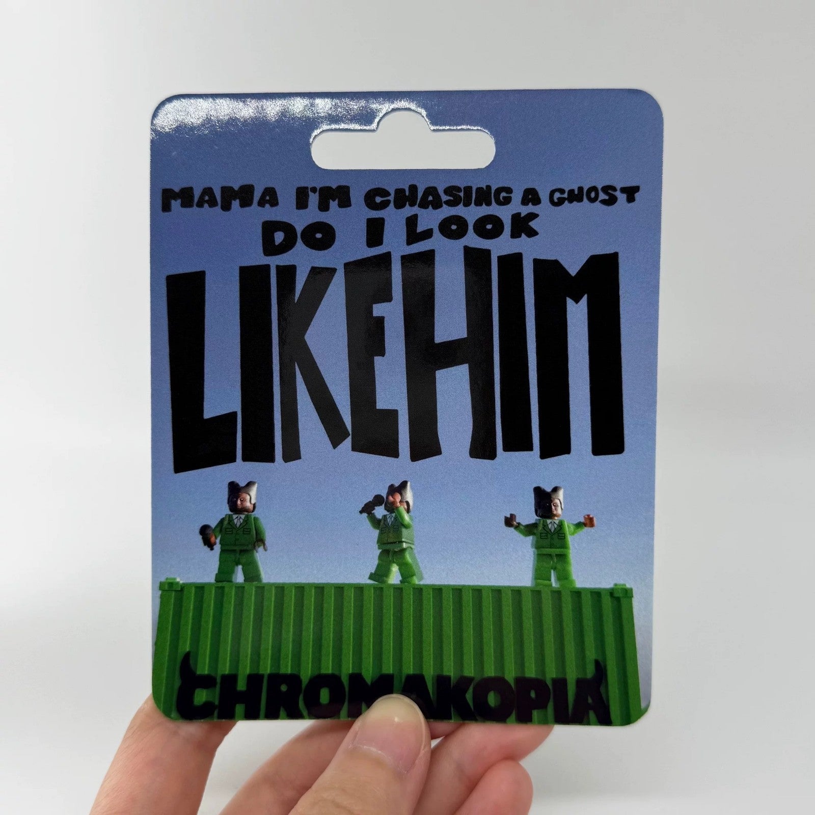 Custom minifigure in green suit, unique hairstyle, displayed on Chromakopia-themed blister card packaging.