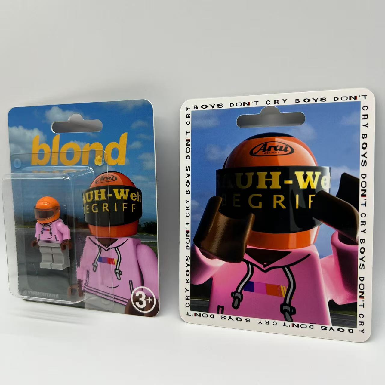 Frank Ocean "Blond" custom minifigure with pink hoodie, orange helmet, in collector-grade blister packaging.