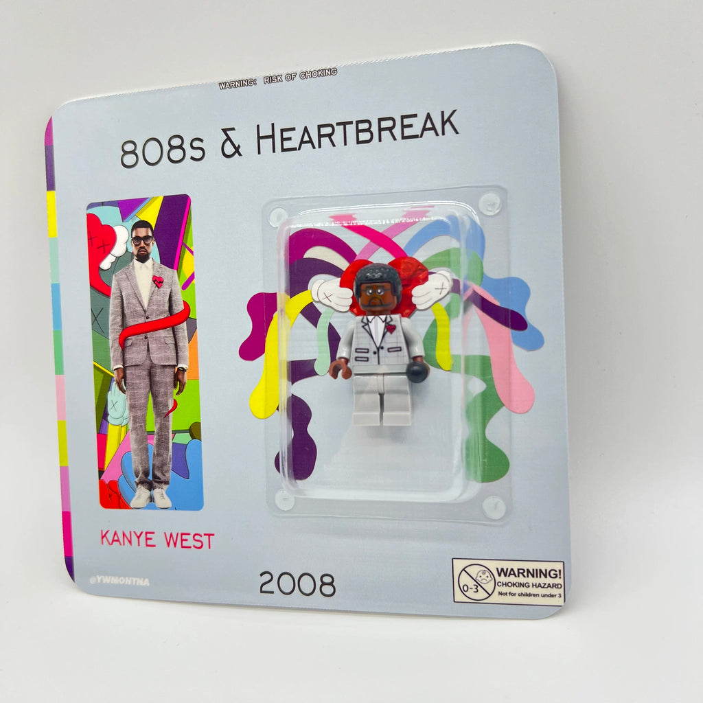 Kanye West "808s & Heartbreak" custom minifigure in grey suit, red heart brooch, collector packaging.