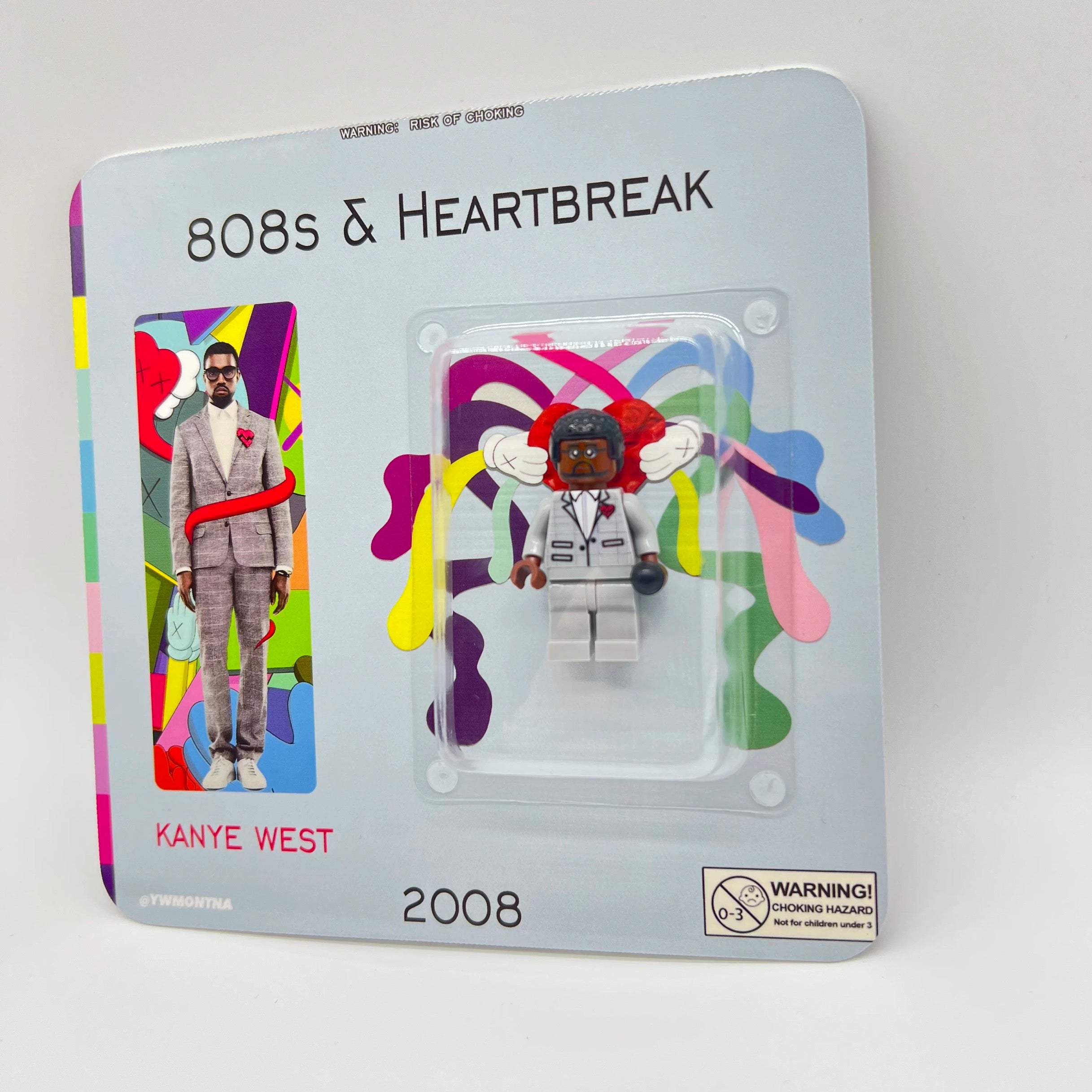 Kanye West "808s & Heartbreak" custom minifigure in grey suit, red heart brooch, collector packaging.