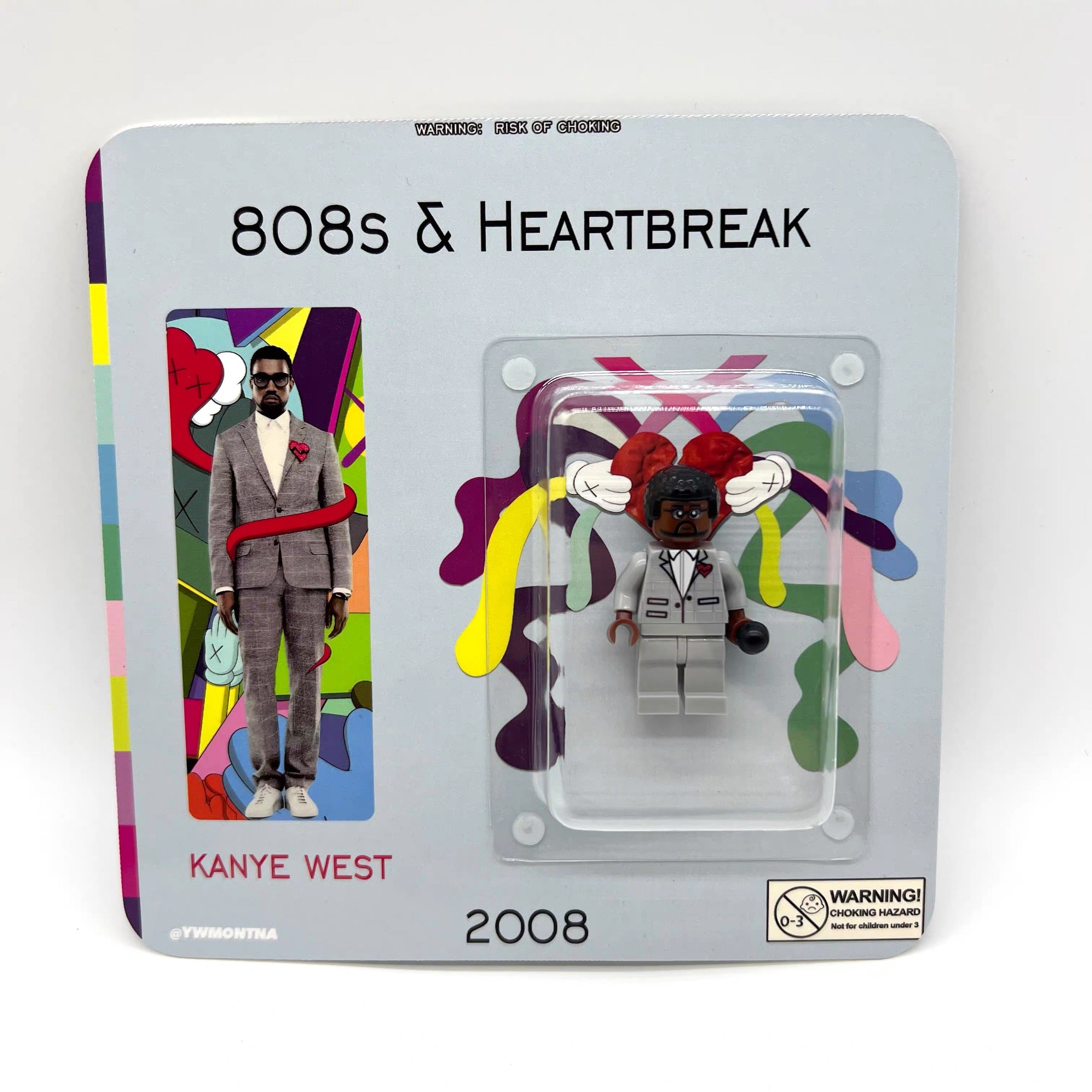 Kanye West 808s & Heartbreak minifigure, grey suit, red heart brooch, collector packaging.