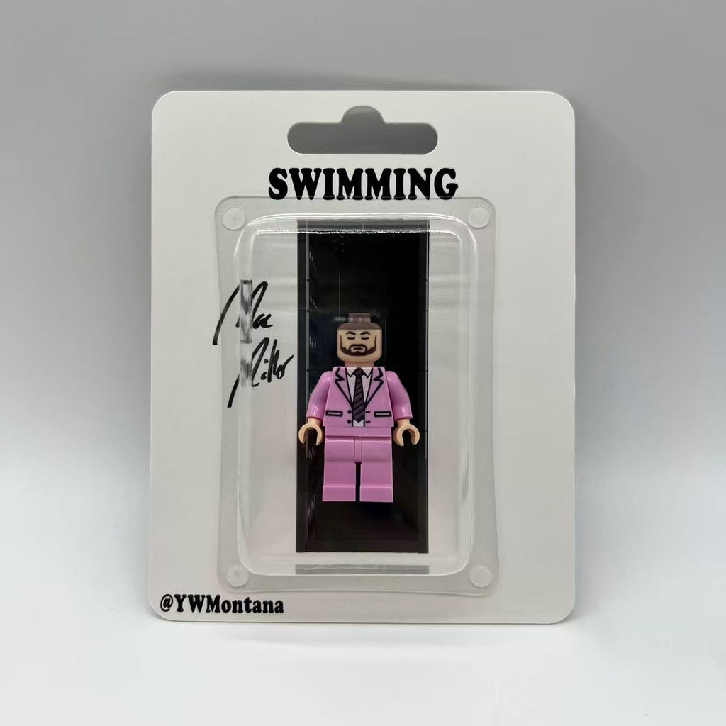 Mac Miller "Swimming" custom minifigure in a pink suit, displayed in collector's blister pack.