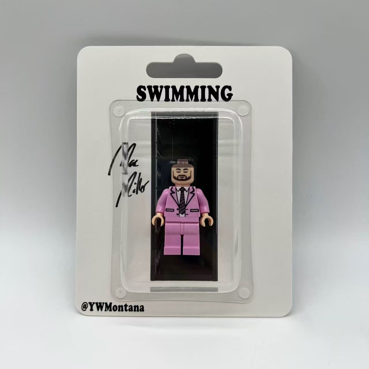 Mac Miller "Swimming" custom minifigure in a pink suit, displayed in collector's blister pack.