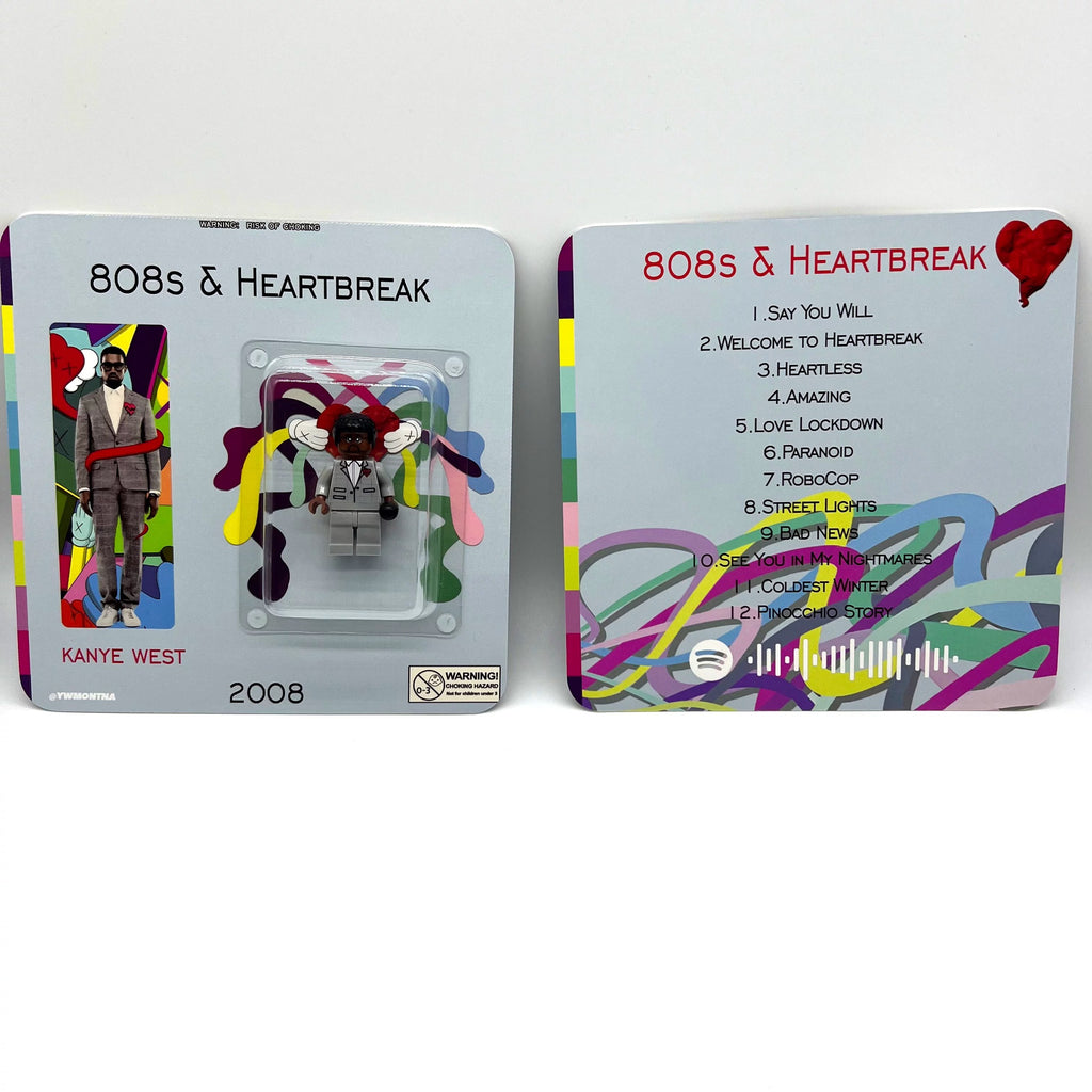 Kanye West "808s & Heartbreak" minifigure in grey suit, red heart brooch; KAWS-inspired colorful packaging.