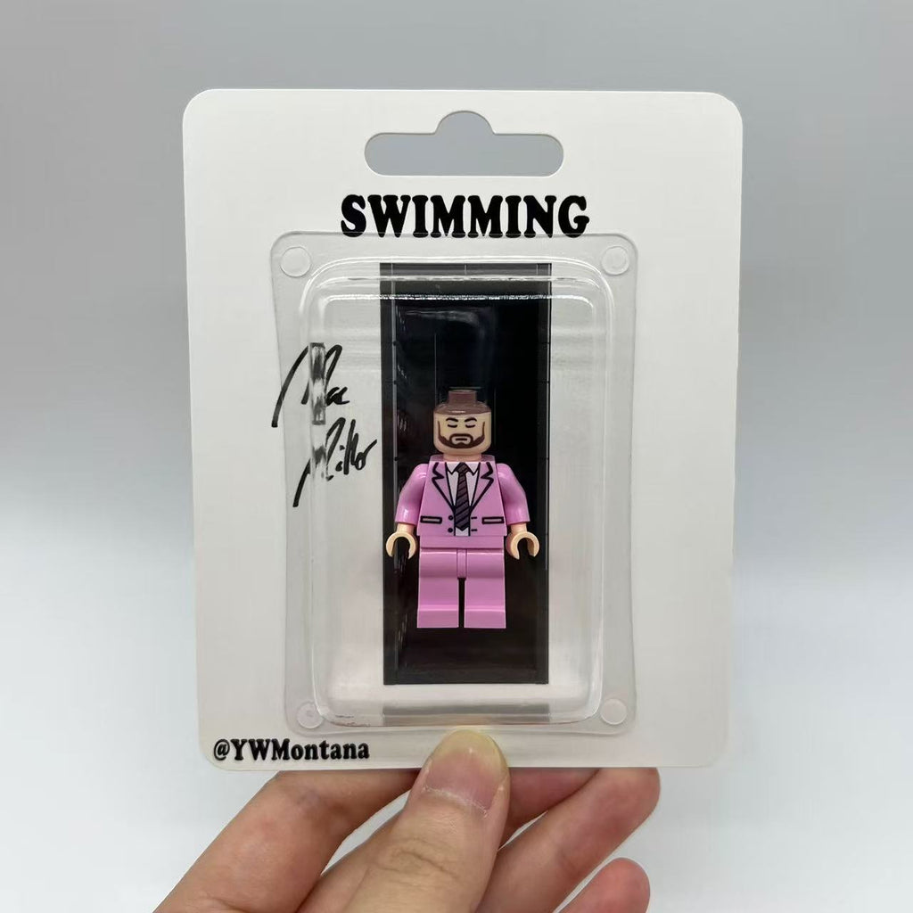 Mac Miller "Swimming" minifigure in pink suit, white shirt; blister packaging with album-themed design.