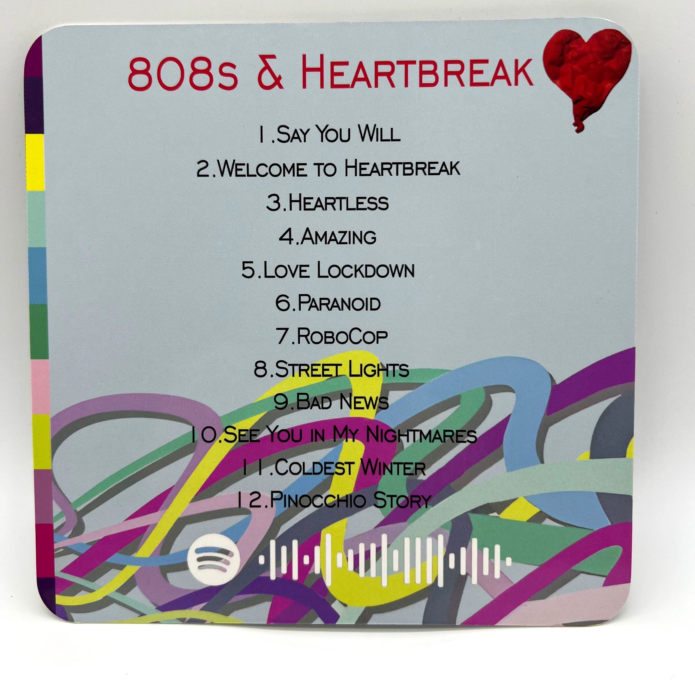 Kanye West "808s & Heartbreak" Minifigure backing card with colorful stripes and tracklist. Includes Spotify code.