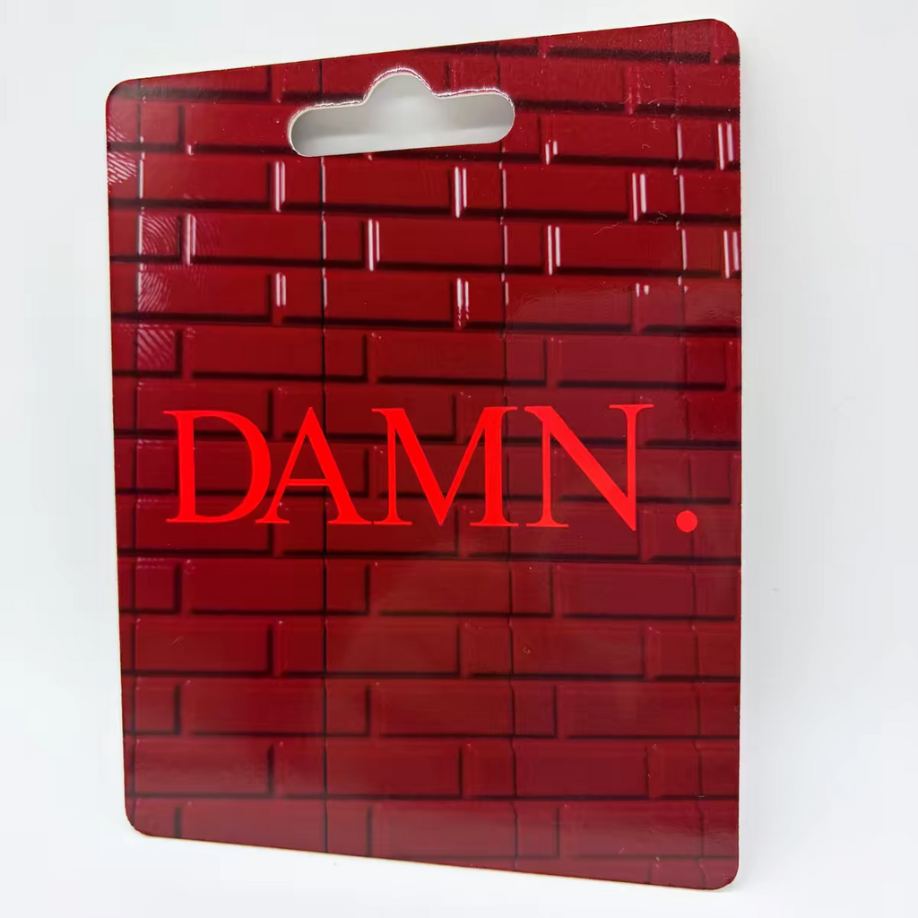 Kendrick Lamar "DAMN." album minifigure packaging with red brick pattern and bold red "DAMN." text.
